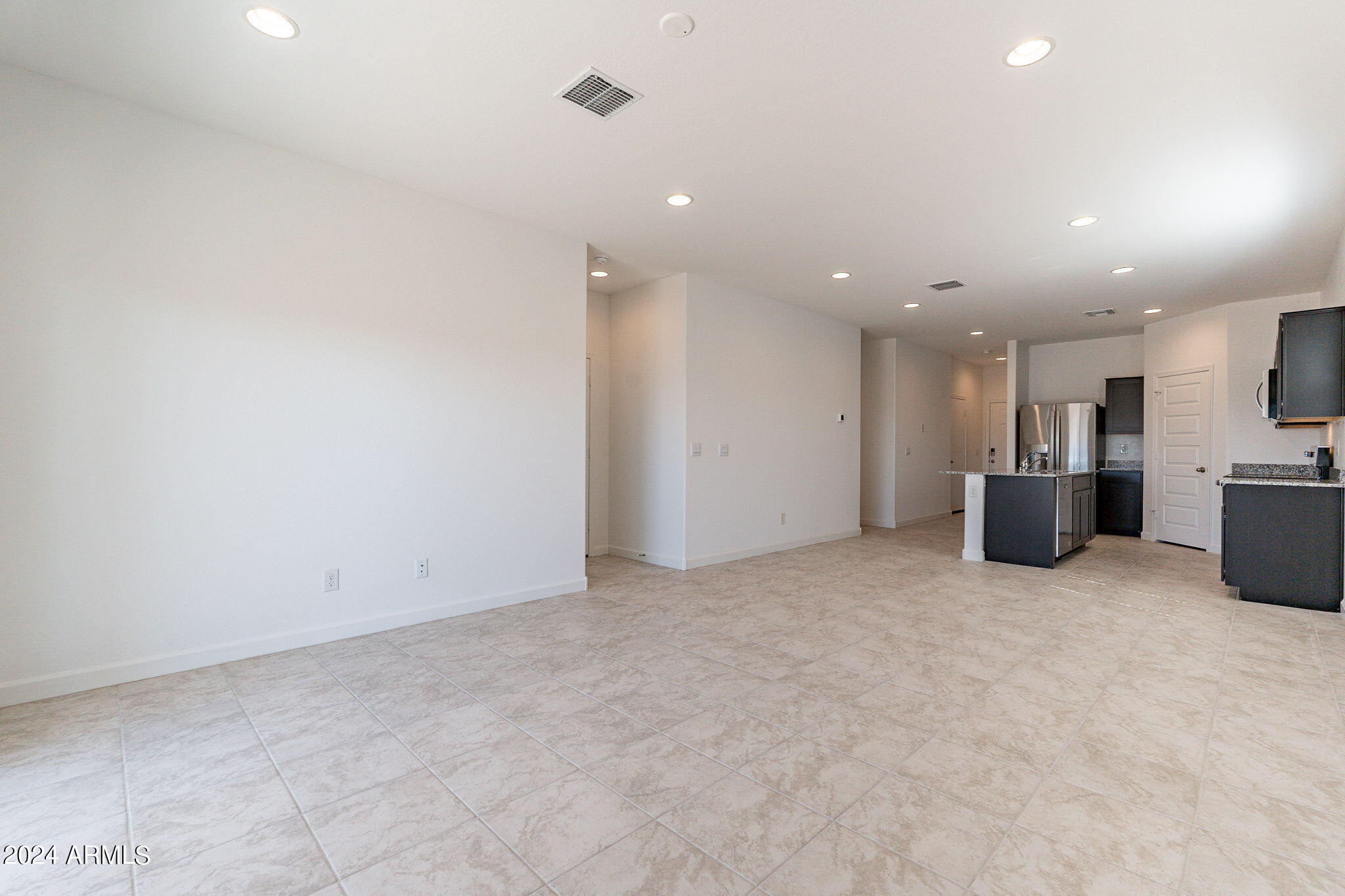 5447 Azara Drive San Tan Valley, AZ 85140 - Photo 9 of 21 an empty room with kitchen and natural light