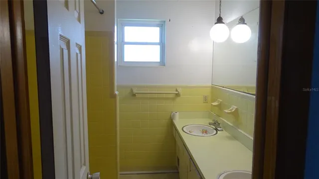 a bathroom with a sink and mirror