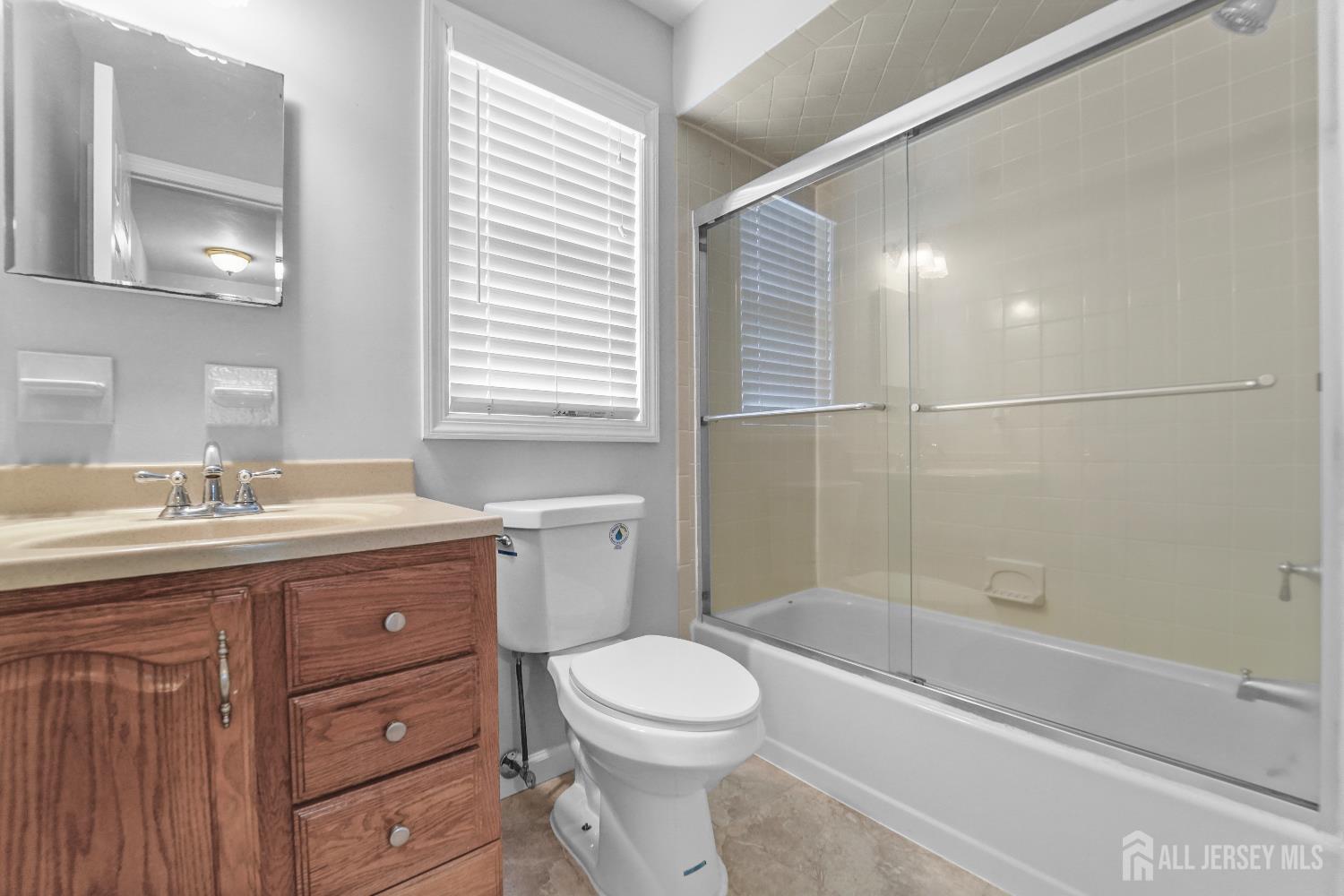169 Docare Road Jackson, NJ 08527 - Photo 19 of 21 a bathroom with a granite countertop toilet a sink and a bathtub