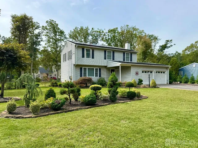a front view of a house with a yard and porch
