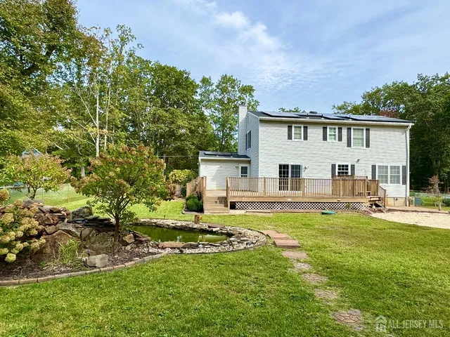 a view of a house with backyard sitting area and garden