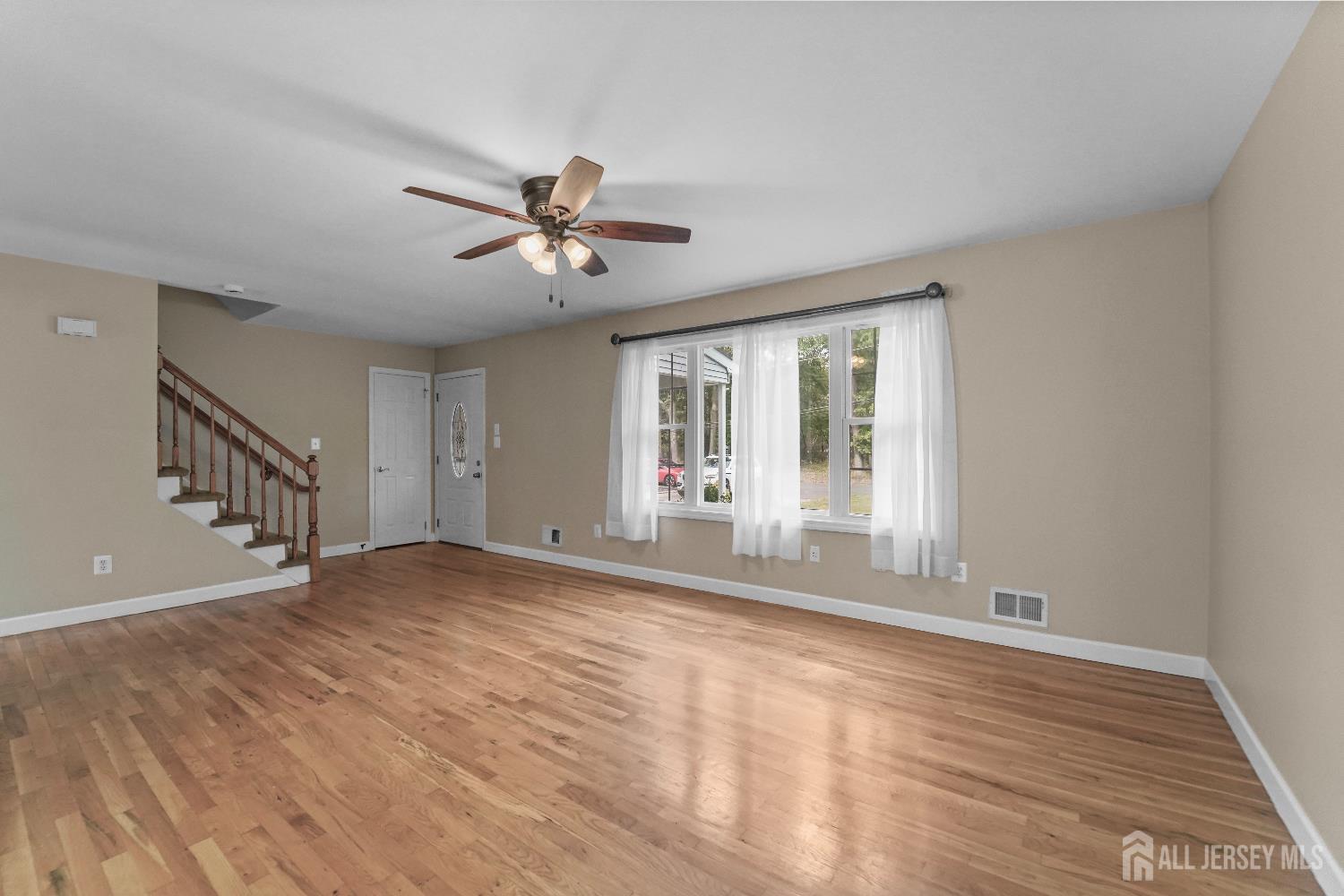 169 Docare Road Jackson, NJ 08527 - Photo 8 of 21 a view of an empty room with a window and wooden floor