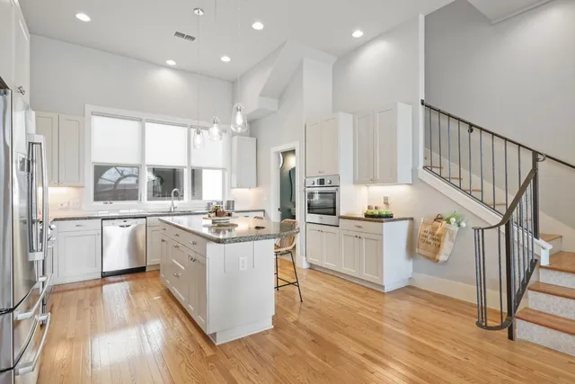 a kitchen with granite countertop a stove top oven and cabinets