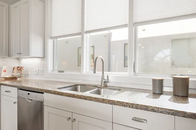 a kitchen with sink and cabinets