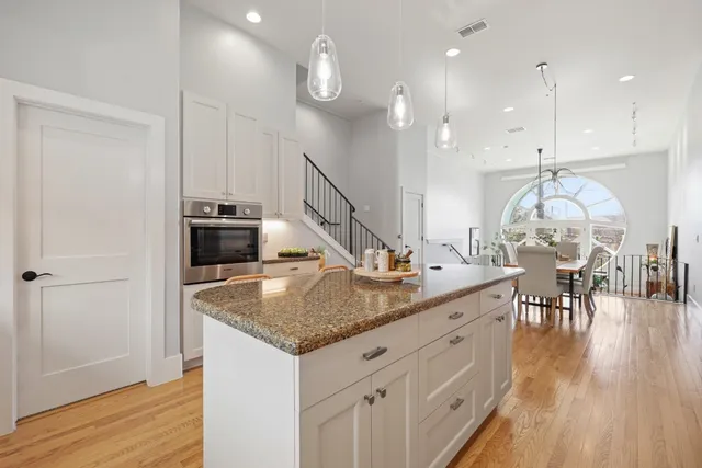 a view of dining table chairs and wooden floor