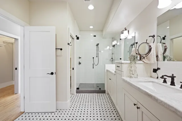 a bathroom with a sink a toilet and shower