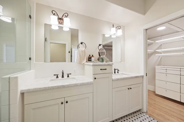 a bathroom with a sink double vanity and a mirror
