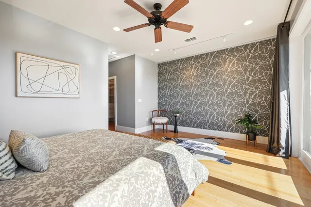 a bedroom with a bed and a chandelier