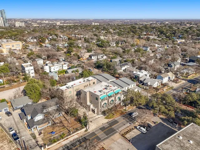 an aerial view of residential building with parking