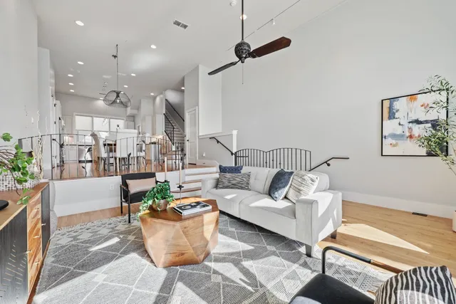 a living room with furniture and a view of kitchen