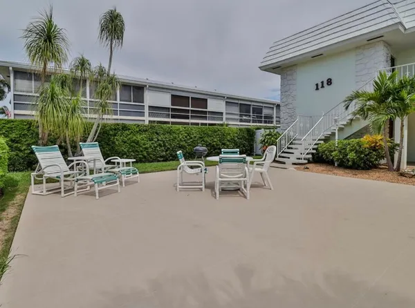a white bench sitting in front of a house