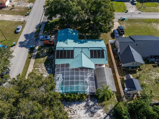 an aerial view of multiple houses with yard