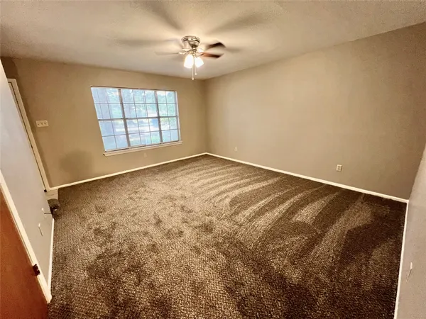 a view of room with window and ceiling fan