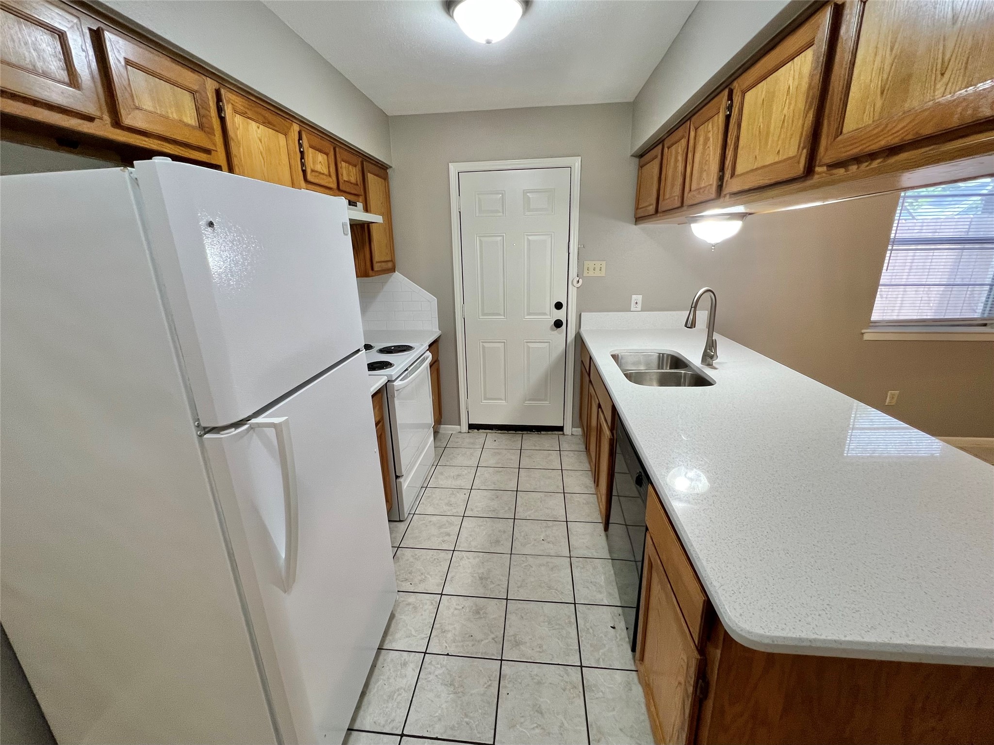 1031-1037 North Chenango Street Angleton, TX 77515 - Photo 6 of 14 a kitchen with stainless steel appliances a refrigerator and a sink