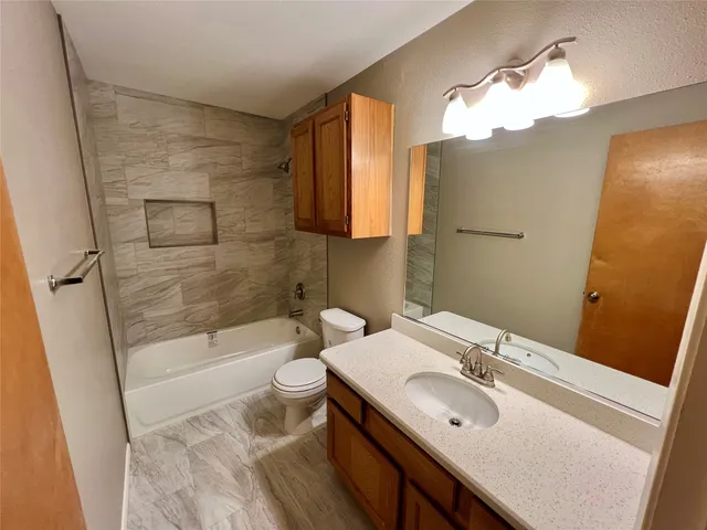 a bathroom with a sink a toilet and bathtub