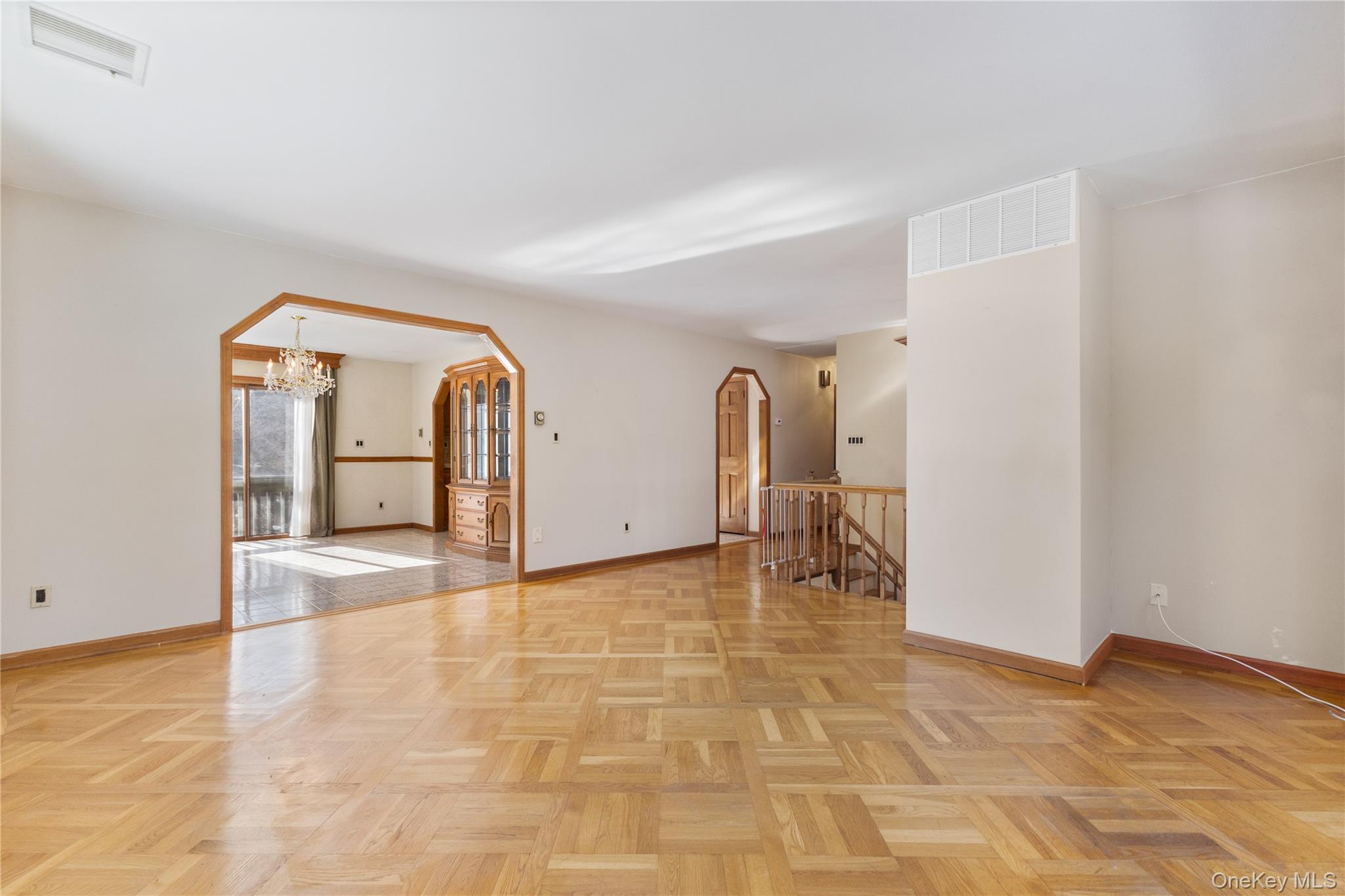 7 Cimarron Road Putnam Valley, NY 10579 - Photo 11 of 50 Living room with detailed parquet flooring, open to the kitchen and hallway leading to the bedrooms.