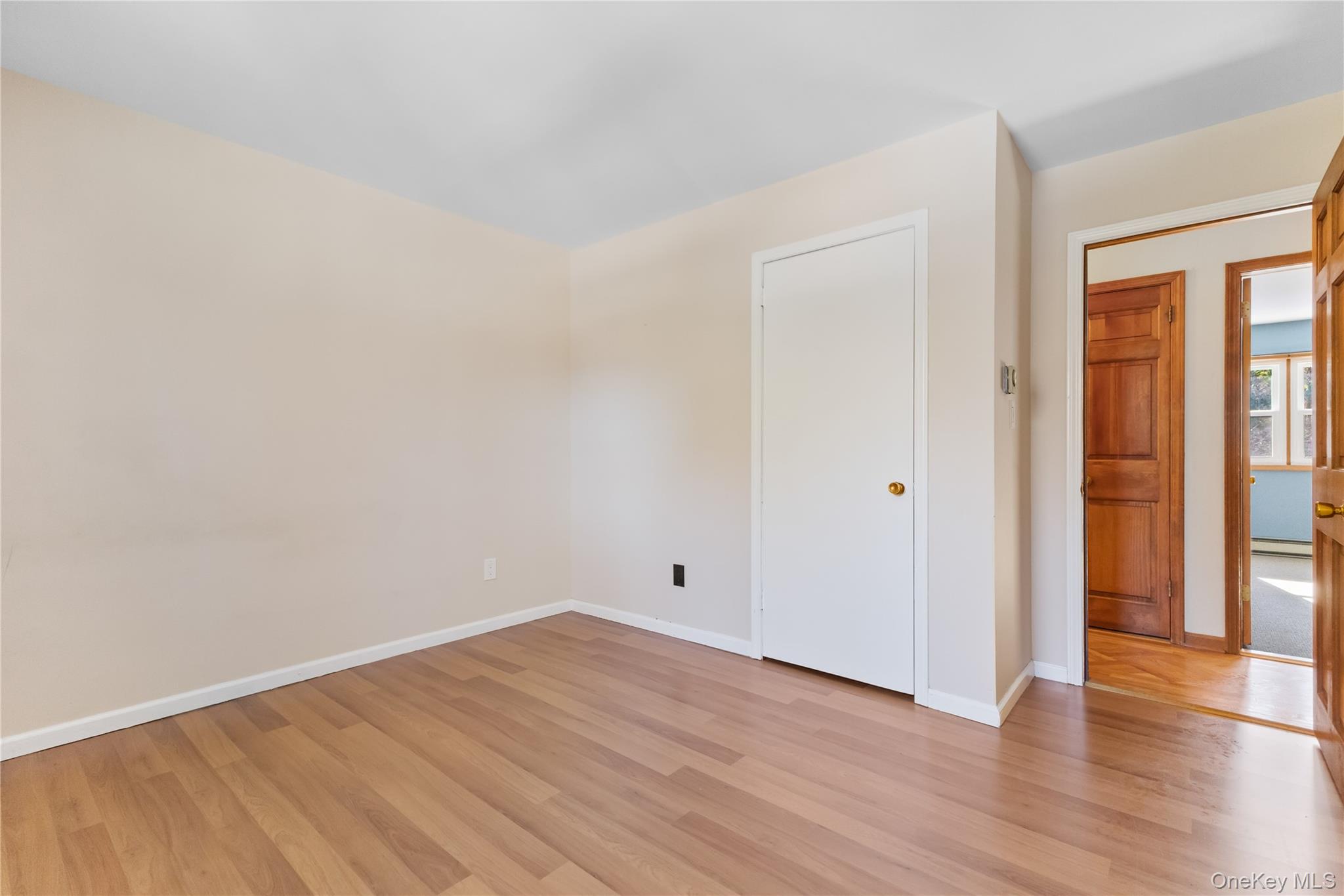 7 Cimarron Road Putnam Valley, NY 10579 - Photo 26 of 50 Cozy bedroom with laminate floors, neutral tones, and a bright window for natural light.