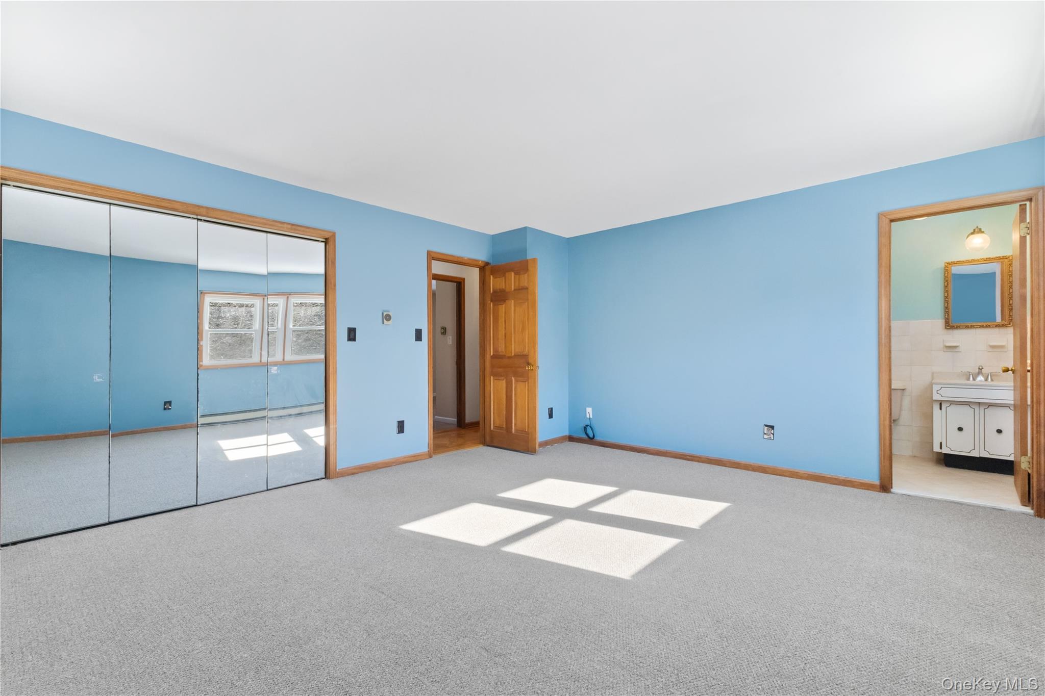 7 Cimarron Road Putnam Valley, NY 10579 - Photo 28 of 50 Spacious primary bedroom featuring a very large mirrored closet and private ensuite access.