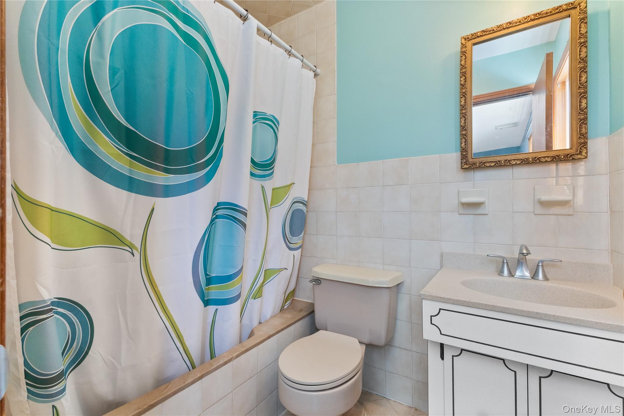 7 Cimarron Road Putnam Valley, NY 10579 - Photo 33 of 50 Private primary bathroom featuring a tiled tub and shower combination, vanity, and ample natural light.