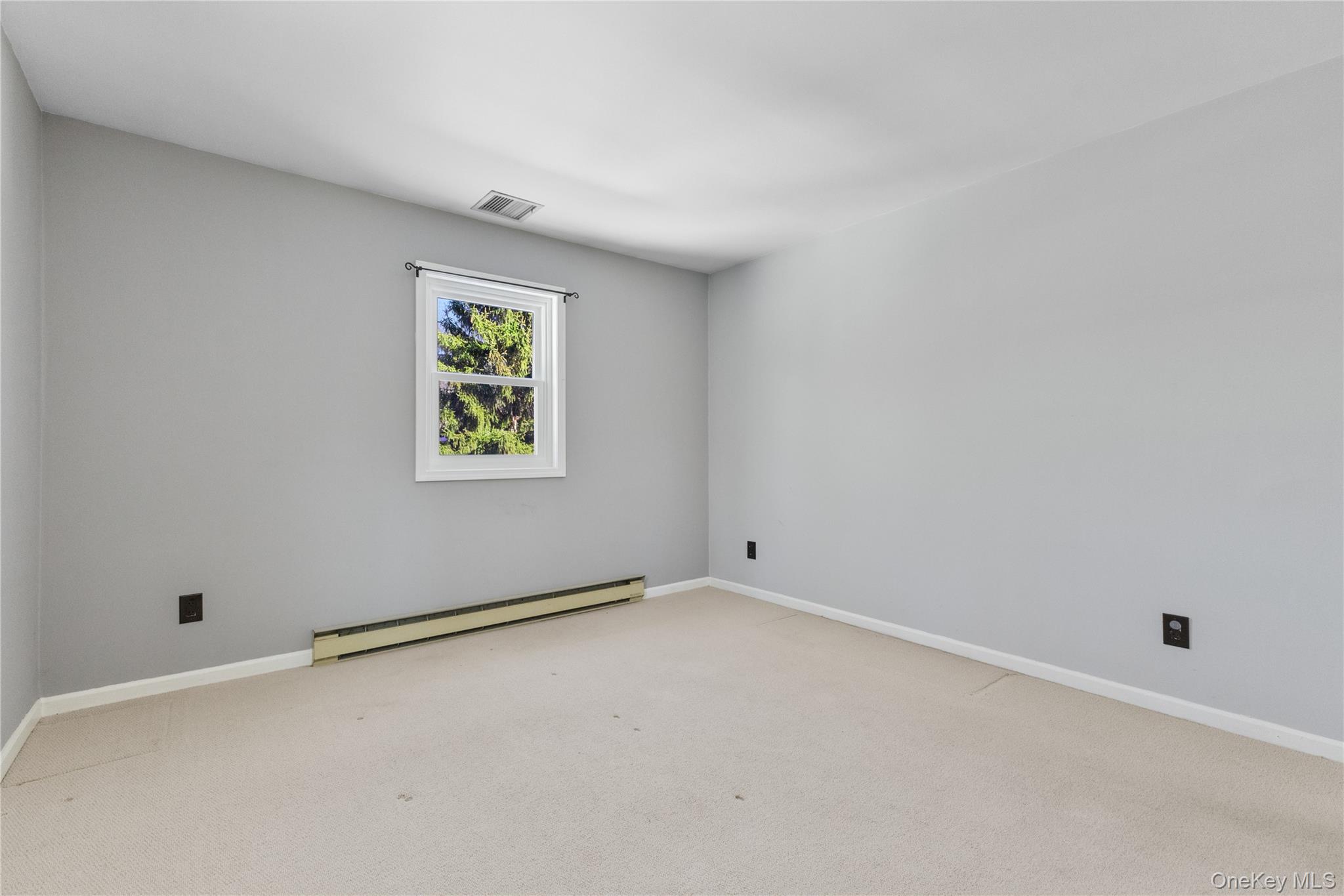 7 Cimarron Road Putnam Valley, NY 10579 - Photo 36 of 50 Charming bedroom with soft neutral walls, cozy carpeting, and a bright window overlooking the yard.