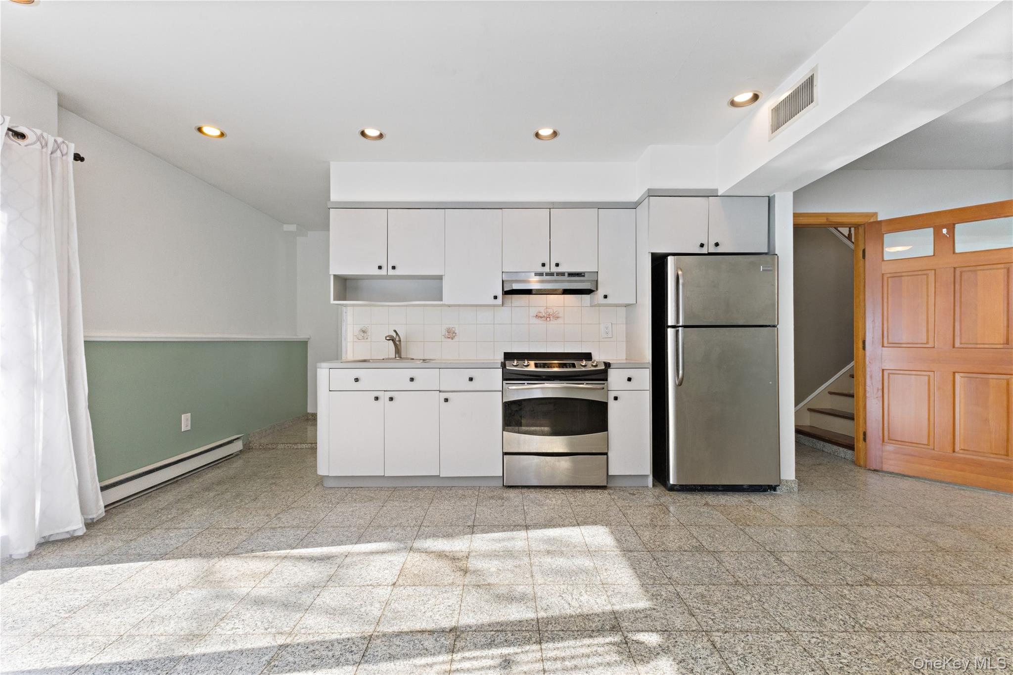 7 Cimarron Road Putnam Valley, NY 10579 - Photo 38 of 50 Spacious family room with recessed lighting, durable tile flooring, and direct access to the backyard—ideal for relaxing or entertaining.