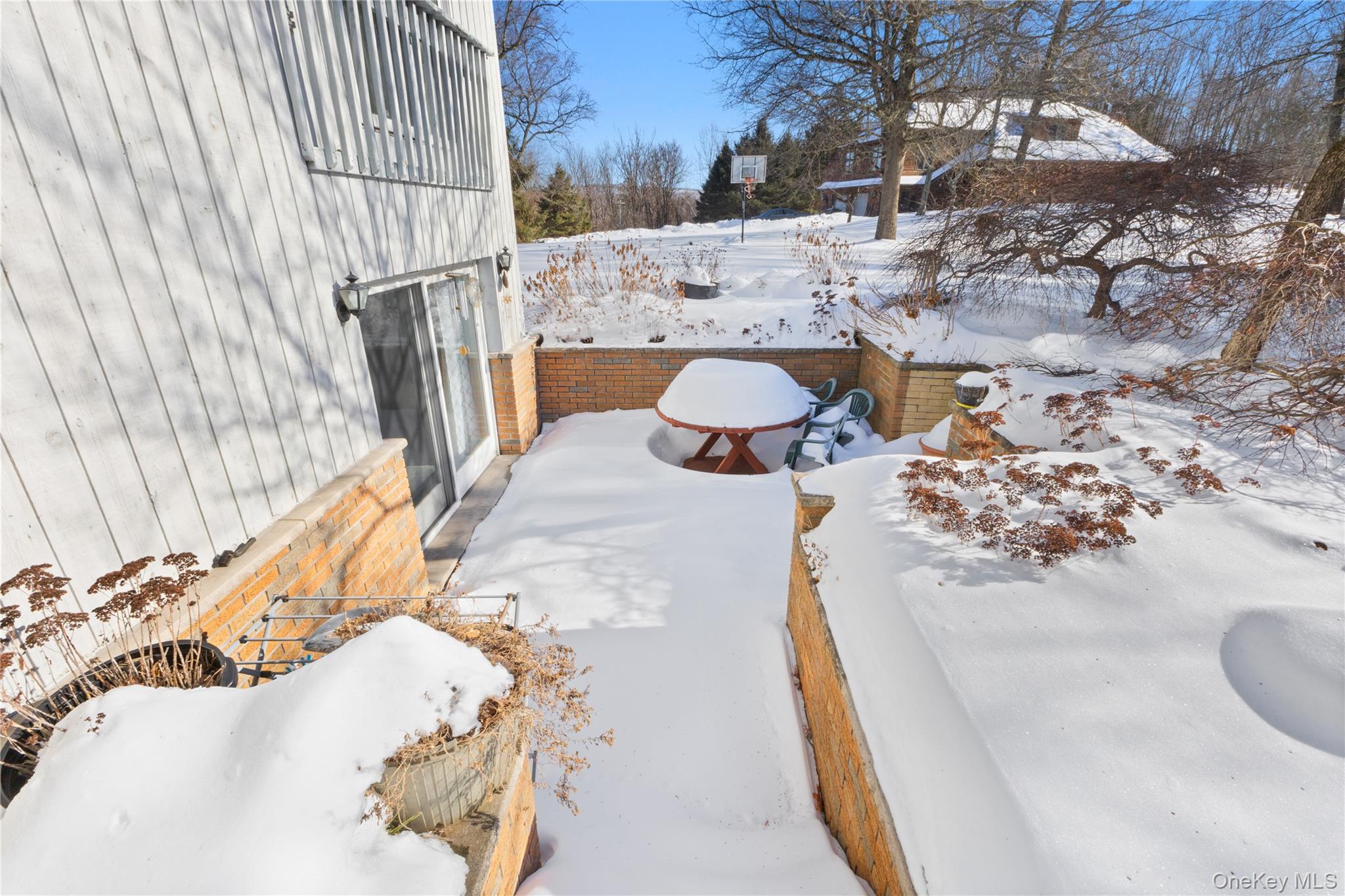 7 Cimarron Road Putnam Valley, NY 10579 - Photo 46 of 50 Private brick patio with sliding door access and views of the spacious backyard.