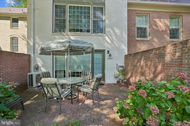 a view of a patio with table and chairs and potted plants