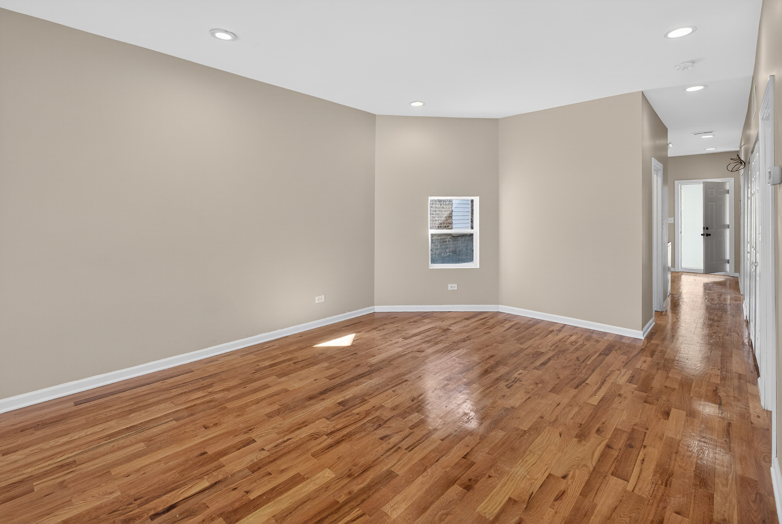5709 West Irving Park Road, Unit 2 Chicago, IL 60634 - Photo 6 of 8 a view of an empty room with wooden floor and a window