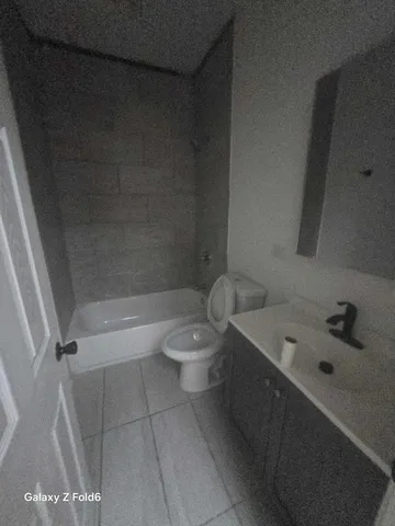a bathroom with a bathtub sink and toilet