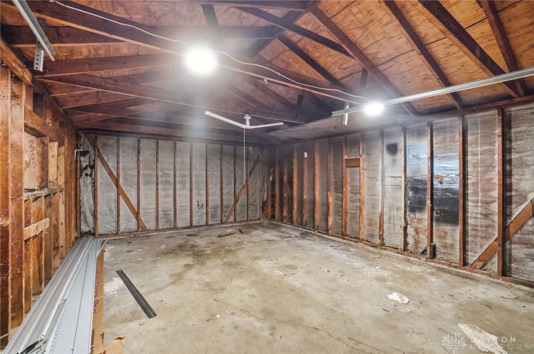 1923 Portage Path Springfield, OH 45506 - Photo 39 of 40 A utilitarian garage space with exposed wooden beams and a concrete floor, ready for transformation.