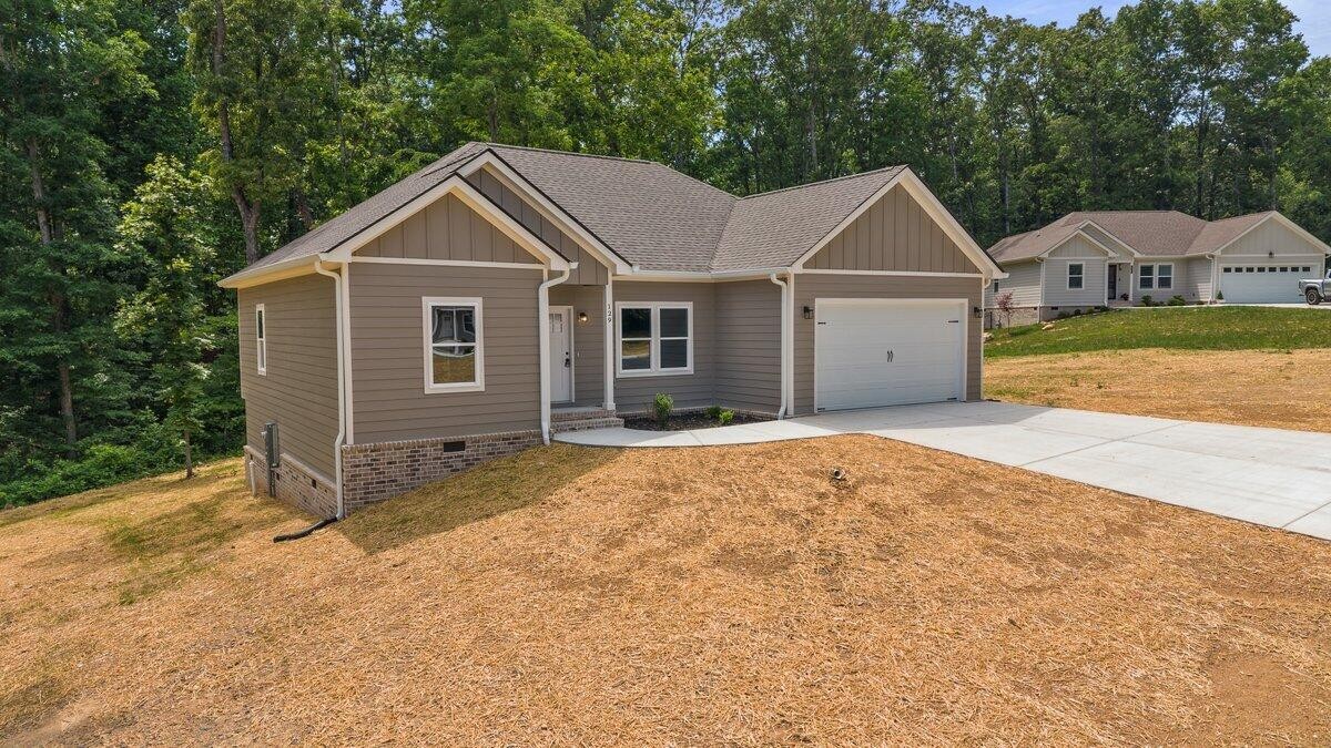 129 County Road 155 Riceville, TN 37370 - Photo 2 of 31 a front view of a house with a yard and garage