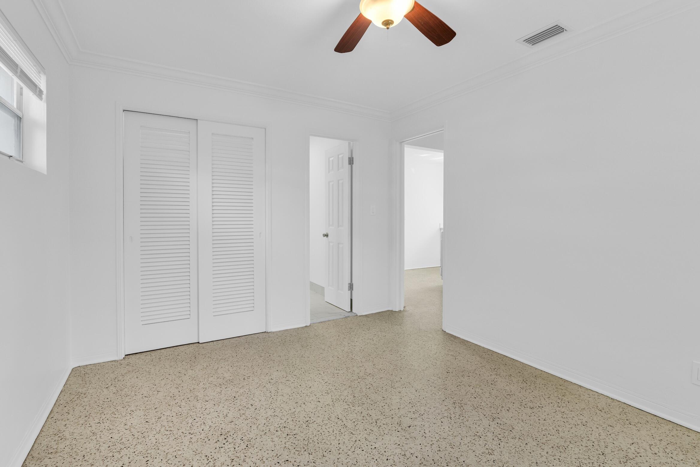 728 North L Street, Unit 2 Lake Worth Beach, FL 33460 - Photo 11 of 13 an empty room with ceiling fan and window