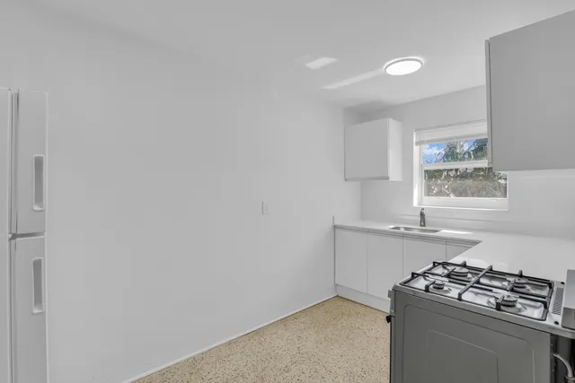 a kitchen with a stove and a window