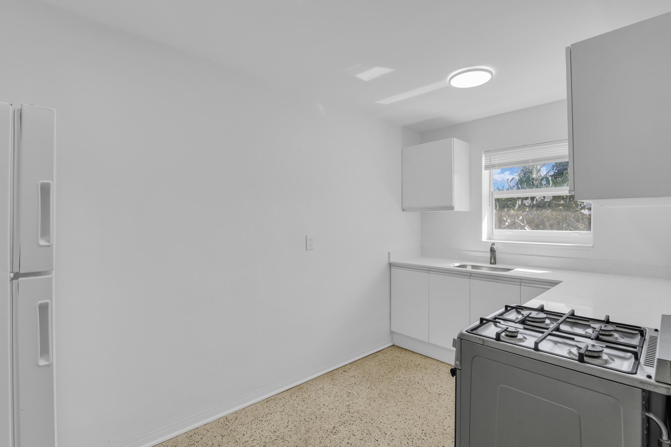 728 North L Street, Unit 2 Lake Worth Beach, FL 33460 - Photo 5 of 13 a kitchen with a stove and a window