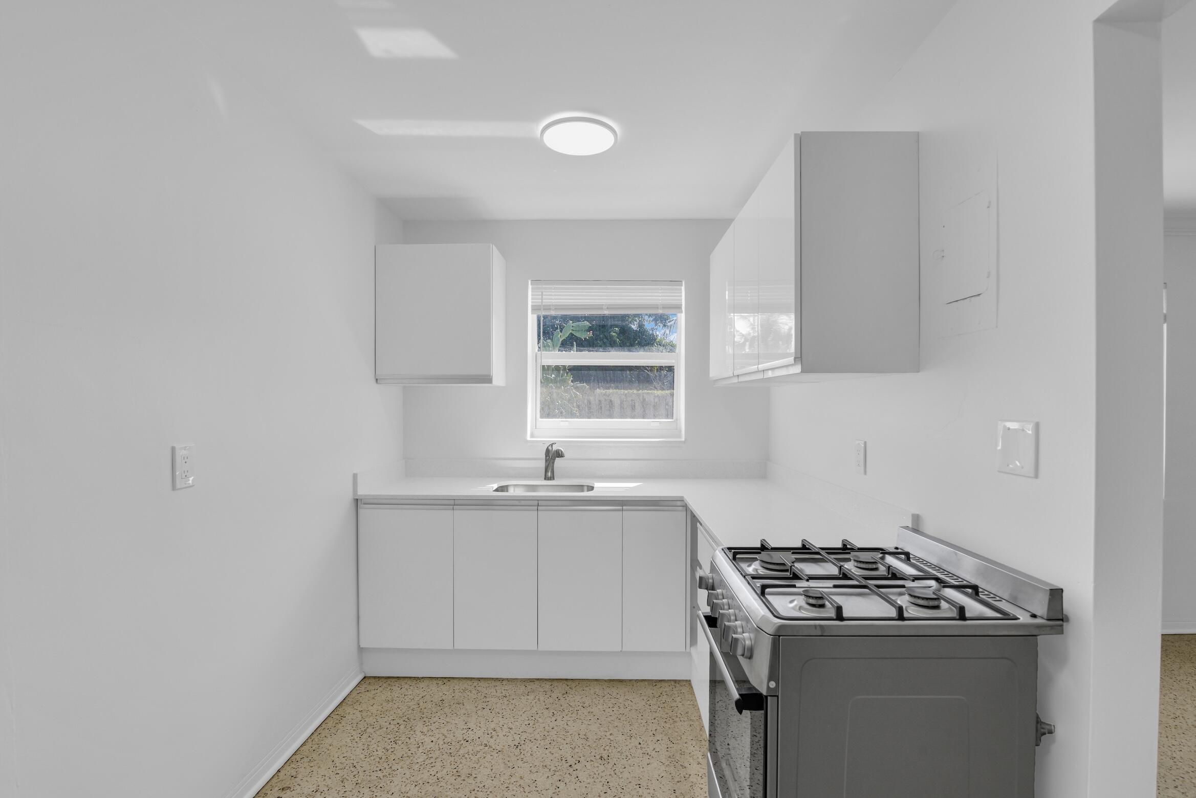 728 North L Street, Unit 2 Lake Worth Beach, FL 33460 - Photo 6 of 13 a kitchen with sink stove and window