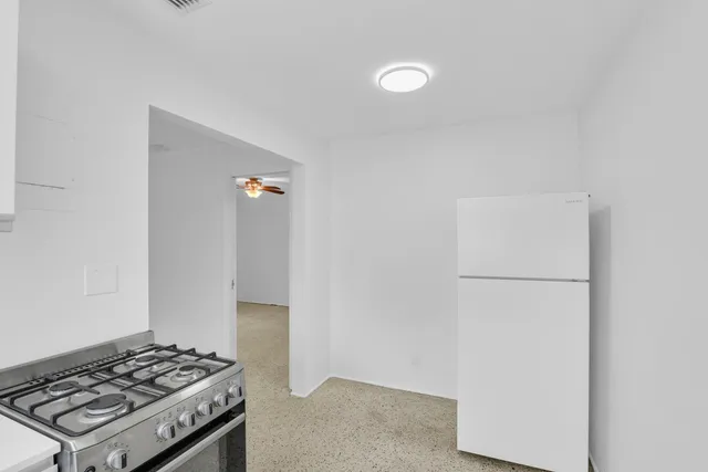 a kitchen with a stove and a refrigerator