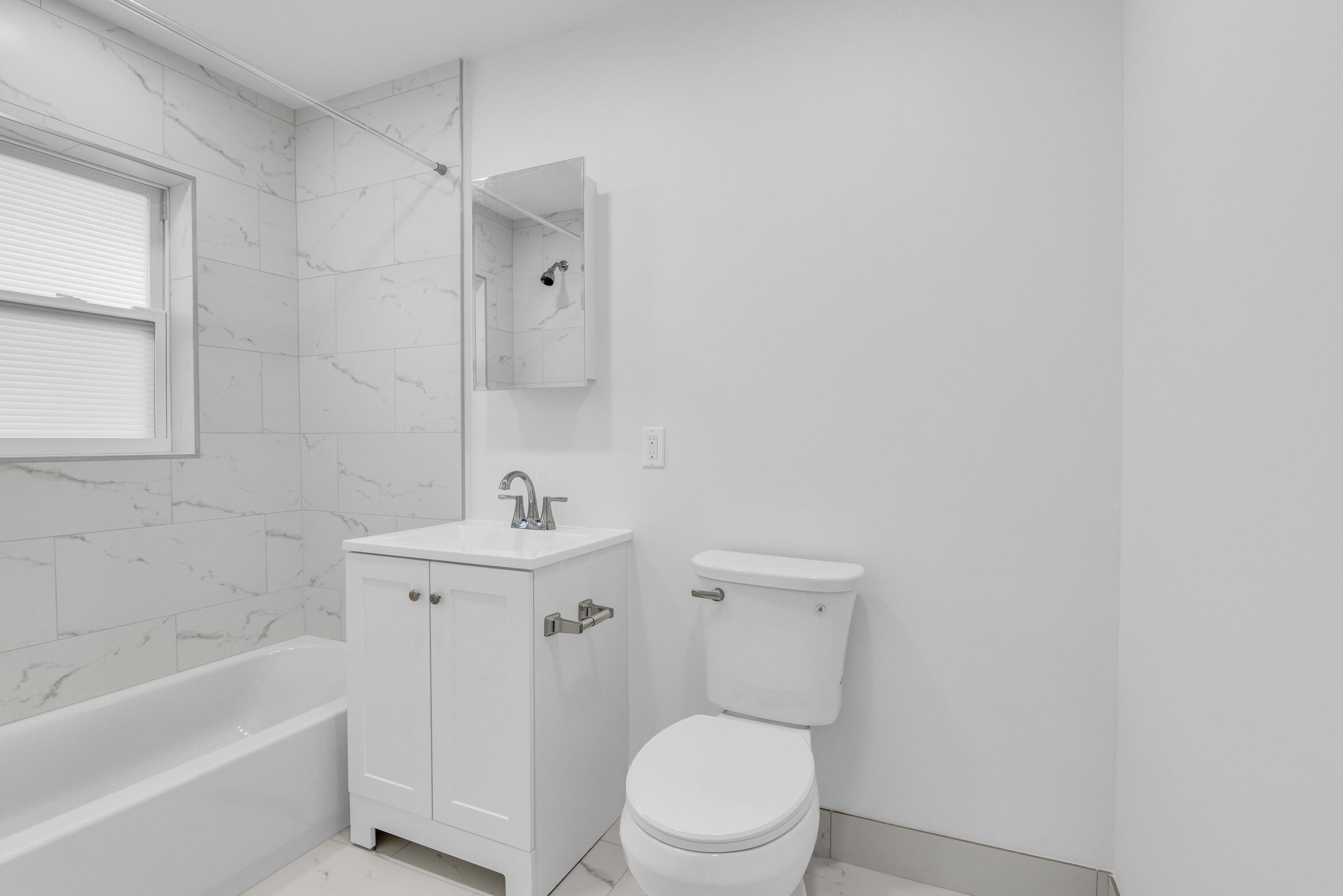 728 North L Street, Unit 2 Lake Worth Beach, FL 33460 - Photo 8 of 13 a bathroom with a sink a toilet and shower