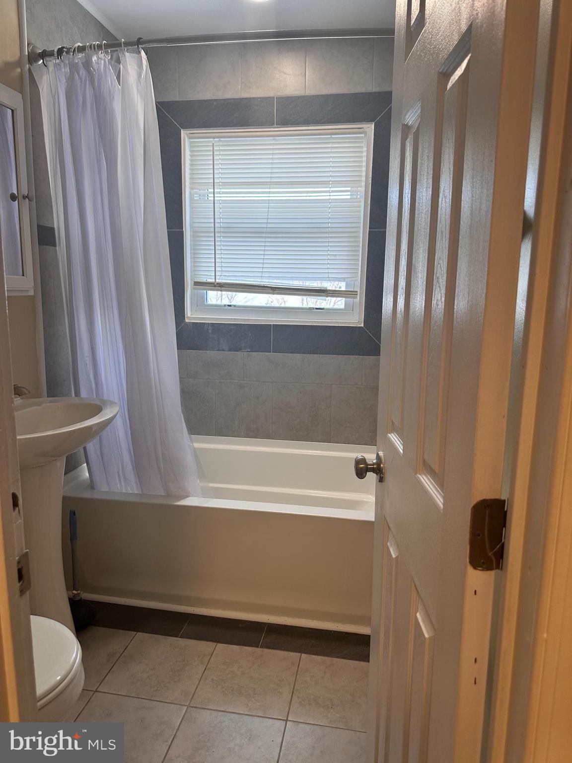 1574 Nathaniel Mitchell Road Dover, DE 19904 - Photo 12 of 15 a bathroom with a bathtub and a shower