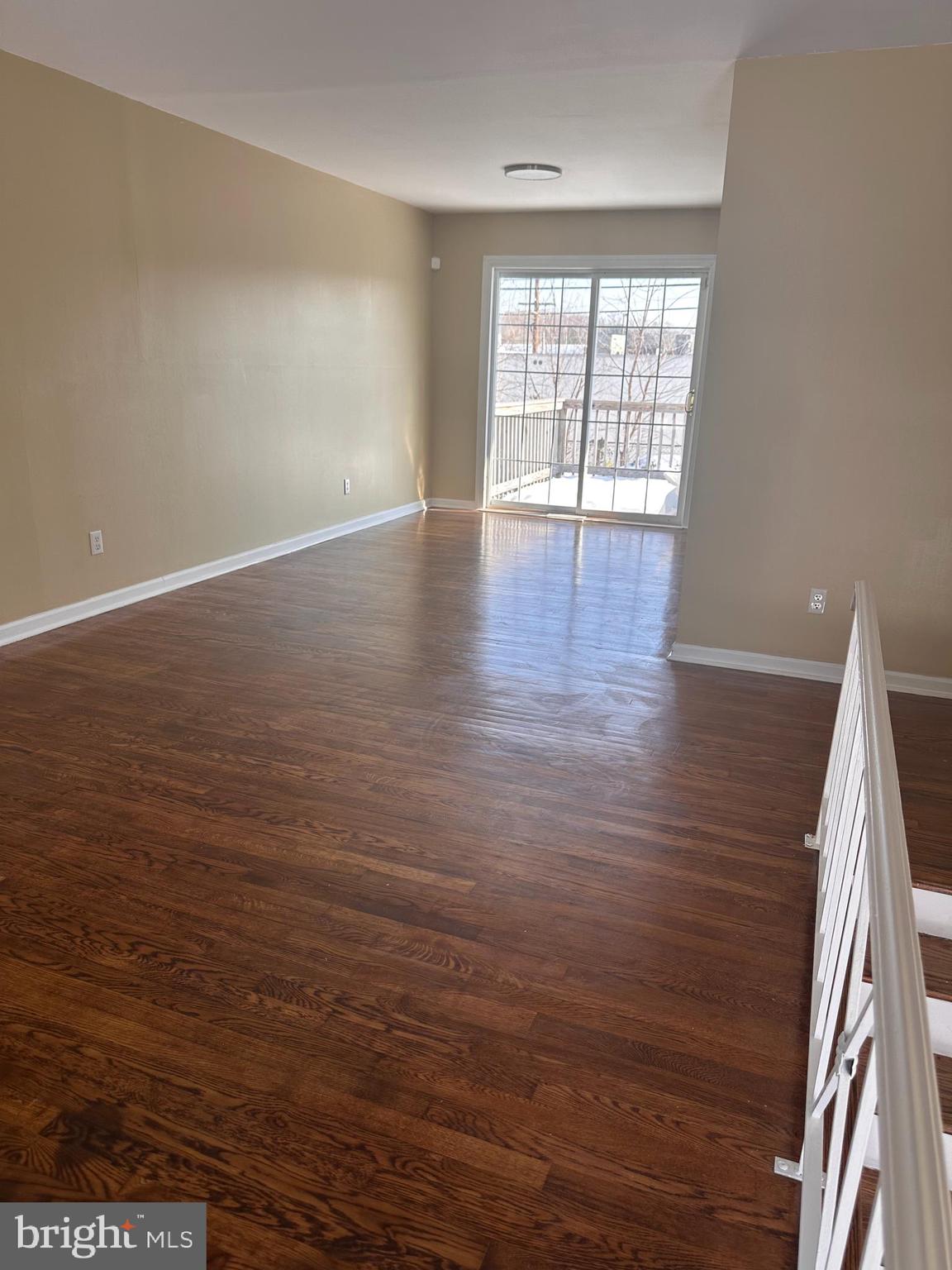 1574 Nathaniel Mitchell Road Dover, DE 19904 - Photo 4 of 15 wooden floor in an empty room with a window