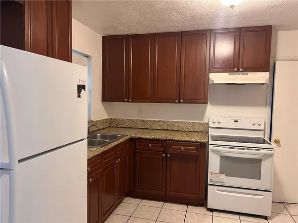 a kitchen with a stove and a refrigerator