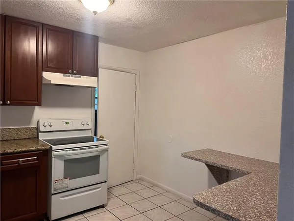 a kitchen with a stove and cabinets