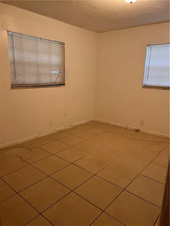 a view of a room with wooden floor and a ceiling fan