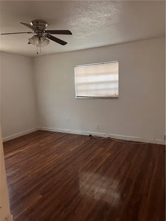 a bathroom with a bathtub a window and a shower