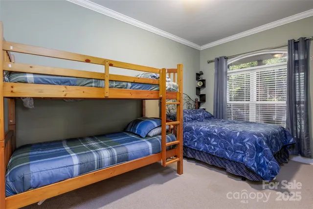 a bedroom with two bed and a flat screen tv