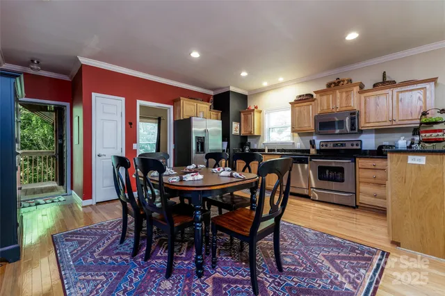 a view of a dining room with furniture and wooden floor