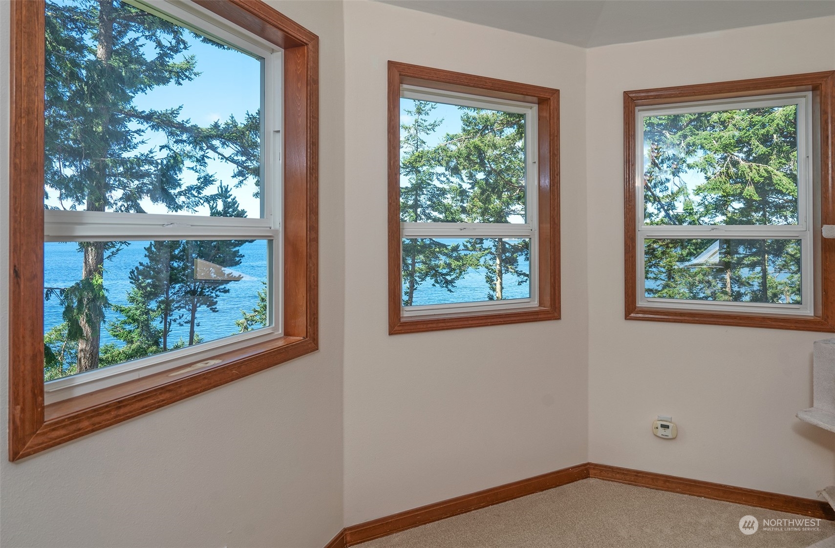 1313 Lopez Road Lopez Island, WA 98261 - Photo 18 of 31 an empty room with wooden floor and windows