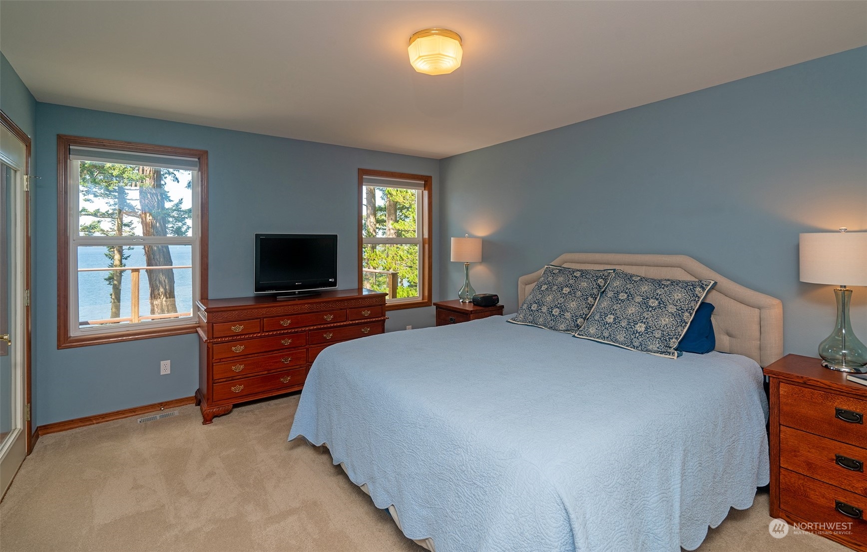 1313 Lopez Road Lopez Island, WA 98261 - Photo 19 of 31 a bedroom with a bed and a flat screen tv