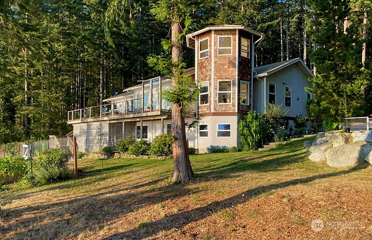 1313 Lopez Road Lopez Island, WA 98261 - Photo 5 of 31 a front view of a house with a yard