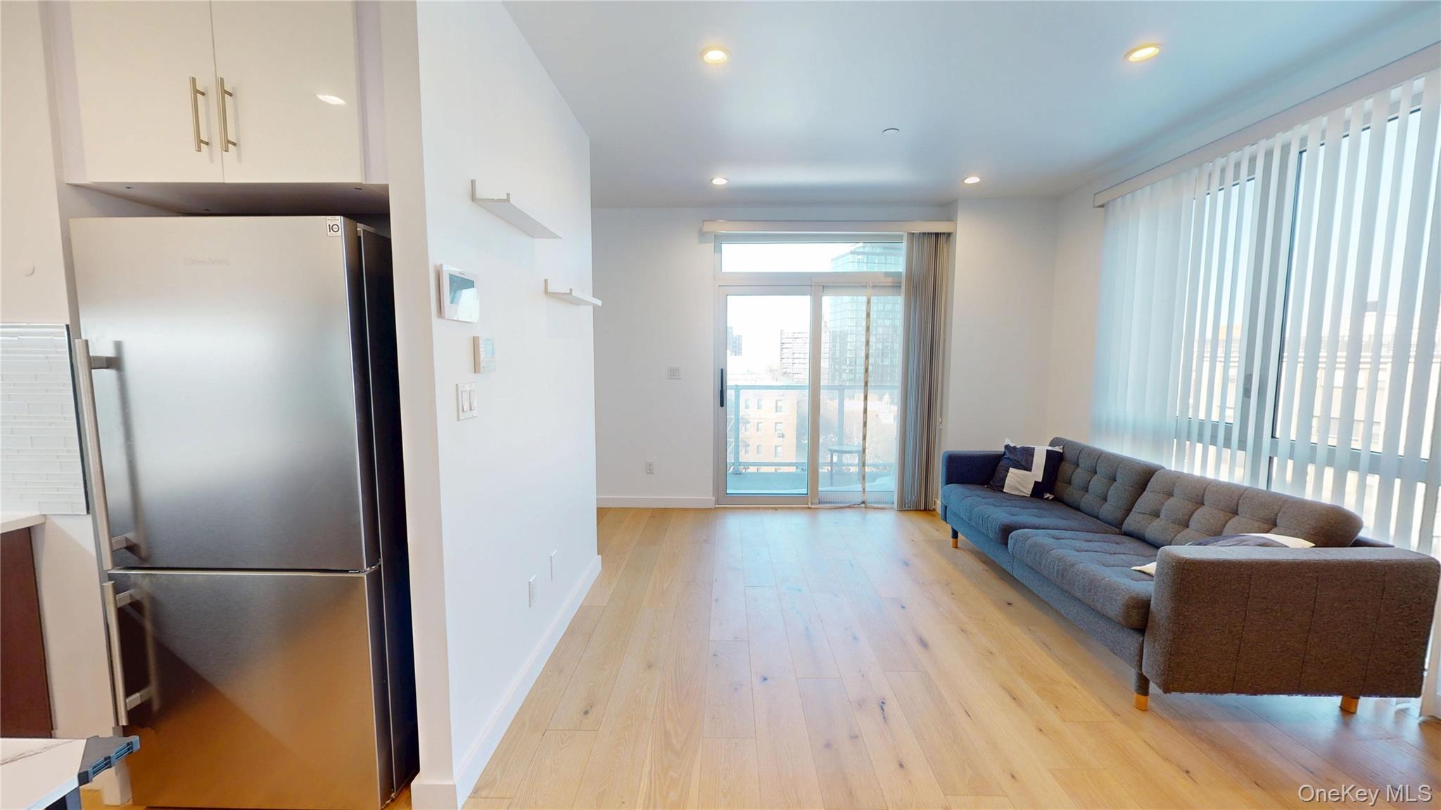 97-29 64th Road Queens, NY 11374 - Photo 3 of 11 a living room with furniture and a window