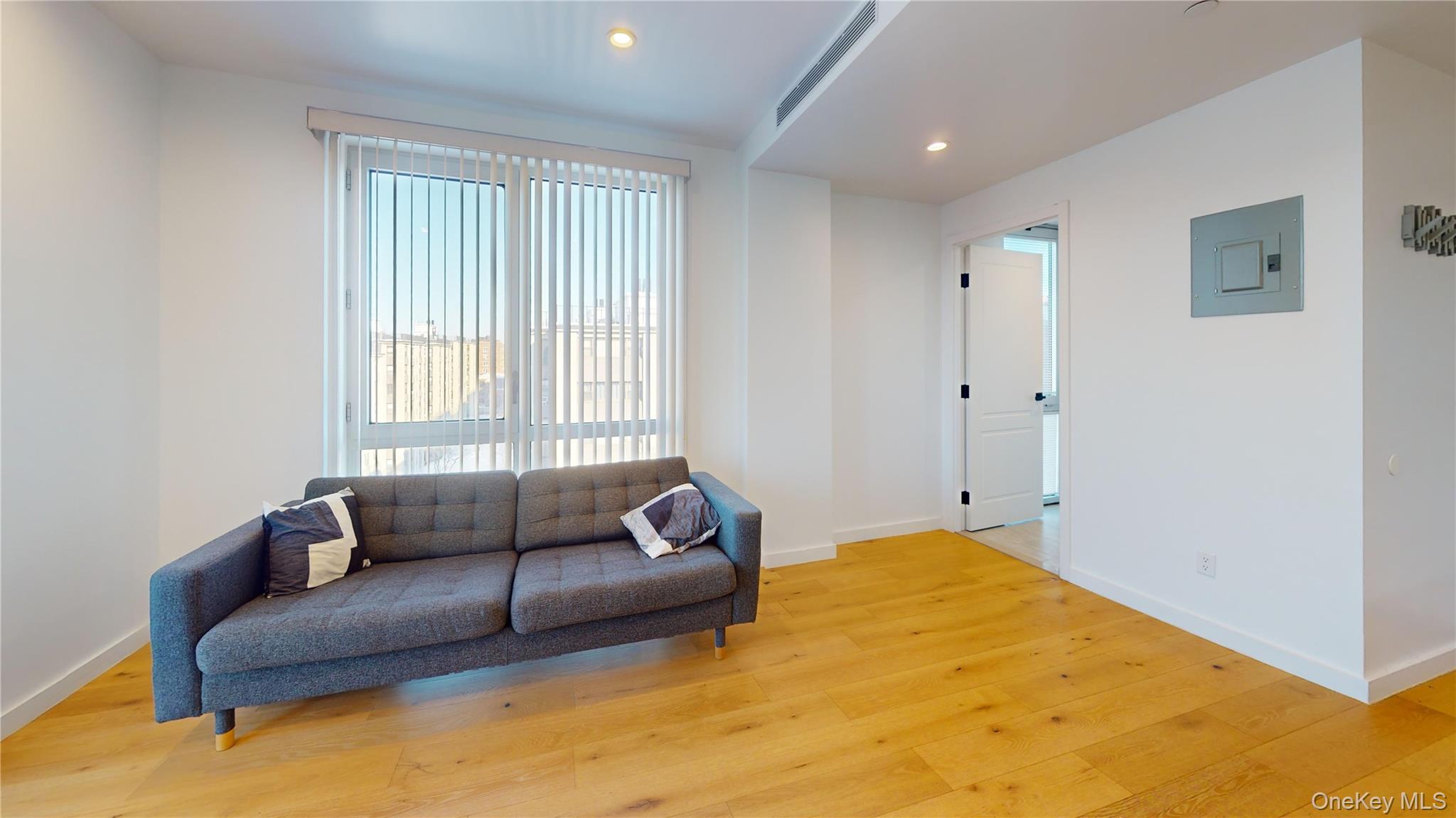 97-29 64th Road Queens, NY 11374 - Photo 4 of 11 a living room with furniture and a window